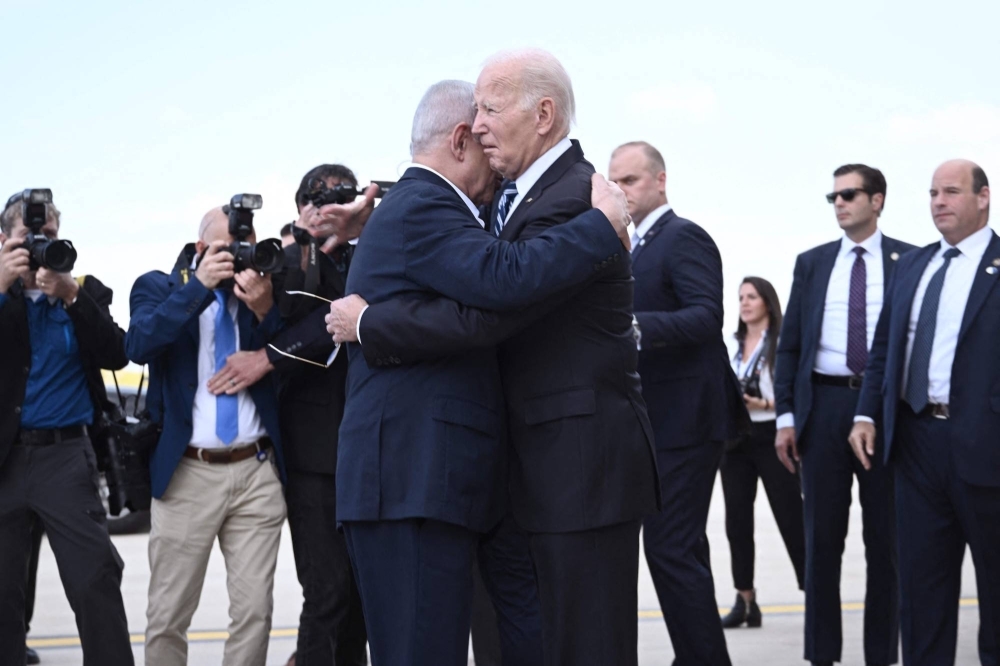 Israeli Prime Minister Benjamin Netanyahu hugs U.S. President Joe Biden upon his arrival at Tel Aviv's Ben Gurion airport on Wednesday. Biden's visit to Israel represents a solidarity visit following Hamas attacks that have led to major Israeli reprisals.