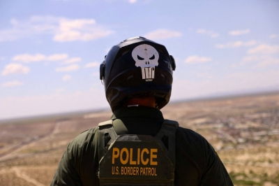 A U.S. Border Patrol agent searches for migrants trying to enter the United States from the Mexico border, in a desert area in Sunland Park, New Mexico.