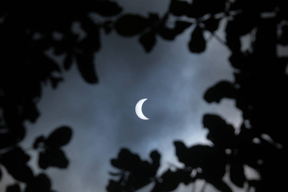 A solar eclipse in Denpasar, Bali, Indonesia, on April 20