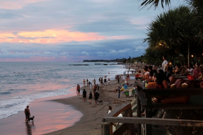 Tourists enjoy the sunset at Bali's Canggu beach in 2021. 