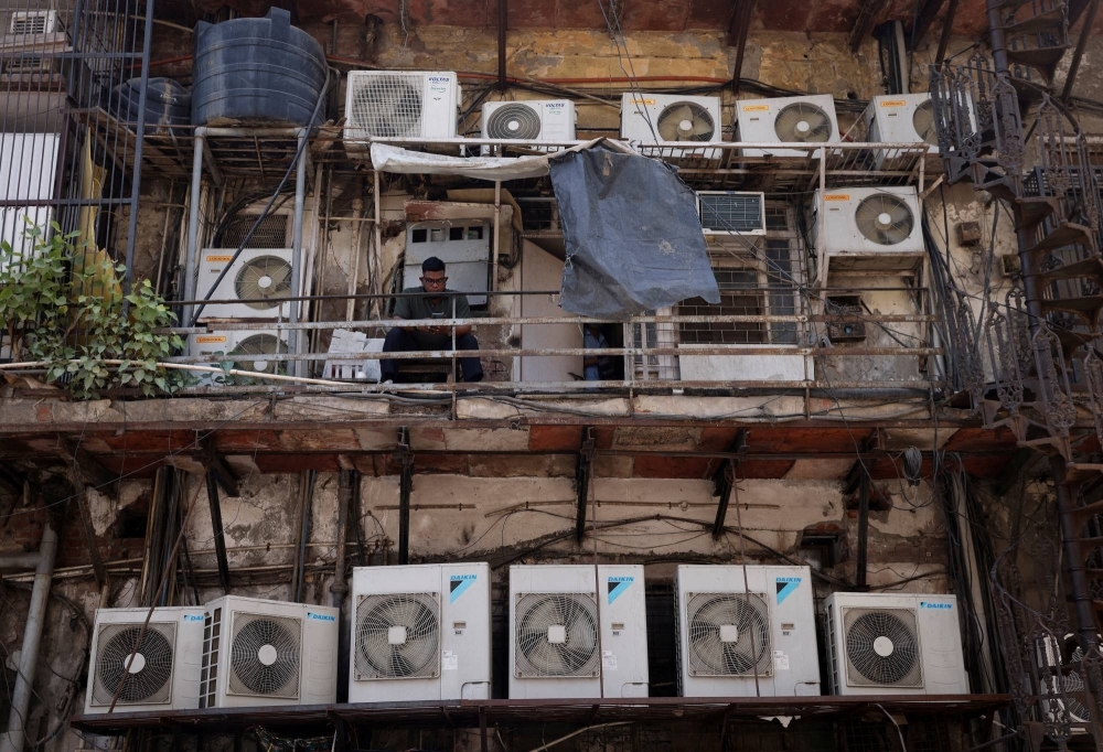 The outer units of air conditioners at the rear of a commercial building in New Delhi