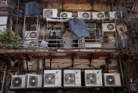 The outer units of air conditioners at the rear of a commercial building in New Delhi | REUTERS