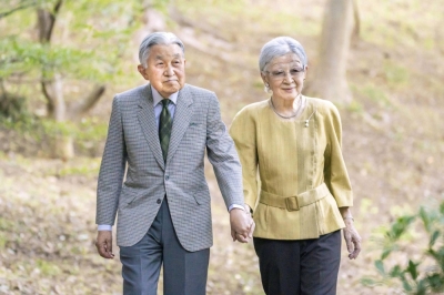 Empress Emerita Michiko, who turned 89 on Friday, walks with her husband, Emperor Emeritus Akihito, at their residence in Tokyo on Oct. 6.