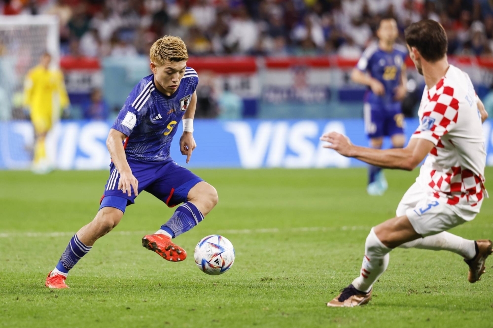 Japan's Ritsu Doan controls the ball in front of Croatia's Borna Barisic during the second half of their match at the 2022 World Cup in Qatar on Dec. 5, 2022.