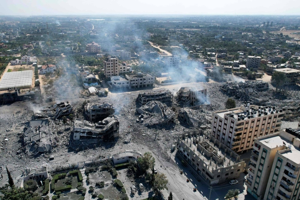 An aerial view shows destroyed buildings in al-Zahra city, south of Gaza City, on Friday following Israeli bombardment overnight amid ongoing battles between Israel and the Palestinian group Hamas. 