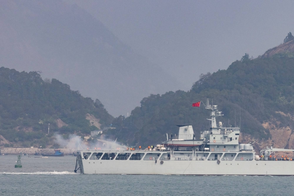 A Chinese warship fires toward the shore during a military drill near the Taiwan-controlled Matsu Islands, which lie off the Chinese coast. 
