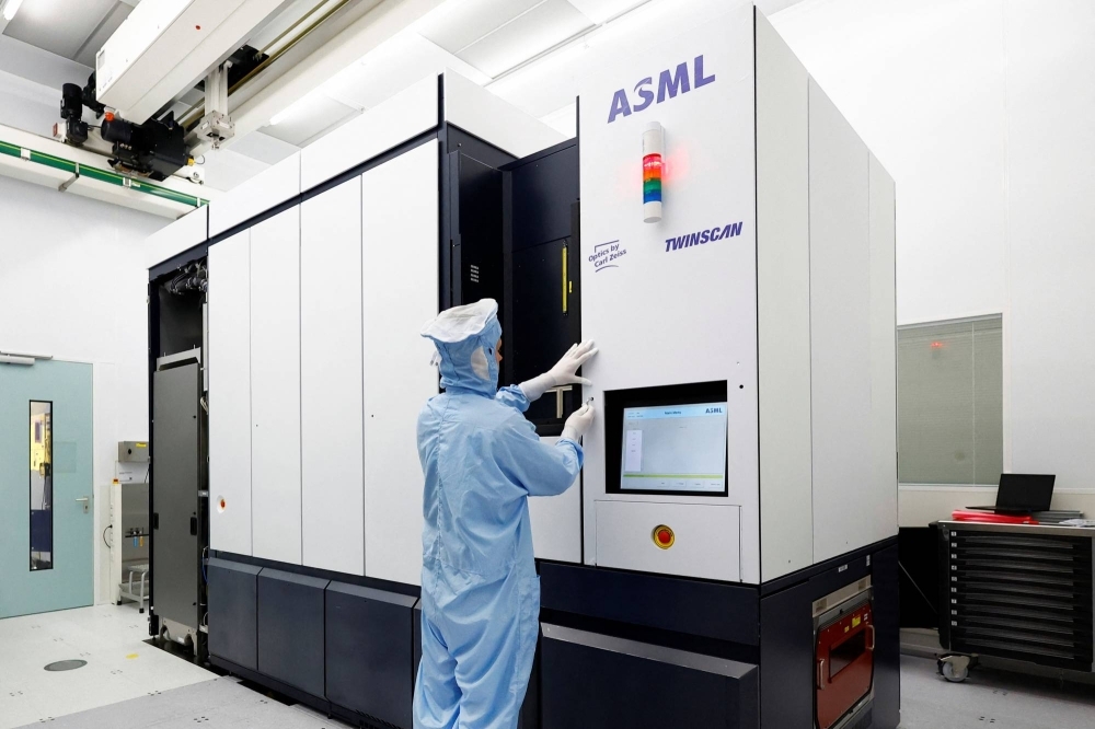 An assembly engineer works on a TWINSCAN DUV lithography system at ASML in Veldhoven, Netherlands, in June.
