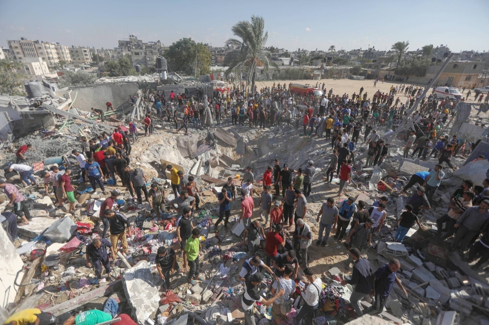 Palestinians inspect destruction from an Israeli airstrike in Khan Younis, a city in southern Gaza, on Thursday. The Israeli bombardment of the Gaza Strip, in retaliation for a deadly Hamas attack on southern Israel, has brought a new outpouring of support in the Arab world for the Palestinian quest for a state. 