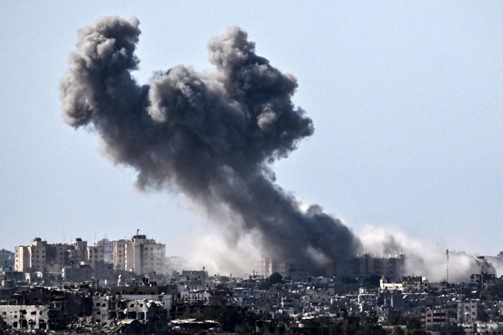Smoke rises over buildings in the Gaza Strip on Saturday amid Israeli strikes. 