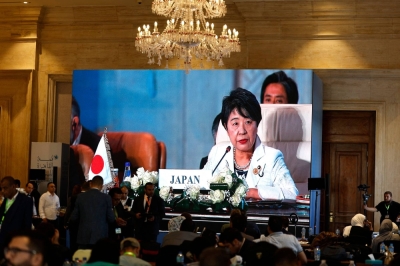 Journalists watch a large screen showing Foreign Minister Yoko Kamikawa addressing the International Peace Summit hosted by the Egyptian president in Cairo on Saturday amid the ongoing fighting between Israel and the Palestinian militant group Hamas.