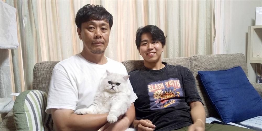 Ryoji Nagai holds Jazz the cat. The Nagais were going to get a dog when son, Yusuke, fell in love with the cat at the shelter.