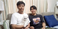 Ryoji Nagai holds Jazz the cat. The Nagais were going to get a dog when son, Yusuke, fell in love with the cat at the shelter. | TOMOMI NAGAI

