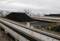 Piles of coal at JERA's Hekinan plant in 2021. Japan aims to lower coal’s share of its energy mix to 19% by 2030, despite calls from the United Nations and environmental organizations for OECD countries to stop all use of coal by then. | Reuters 