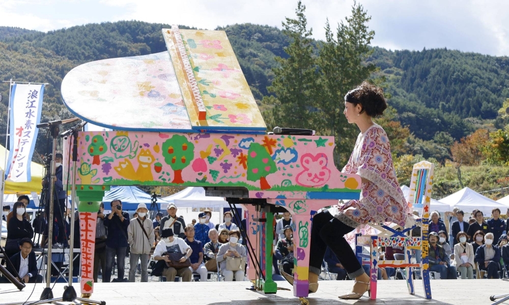 Pianist Yukie Nishimura plays a piano repaired from the 3/11 tsunami damage in Namie, Fukushima Prefecture, on Saturday. 