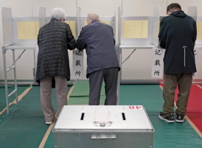 Voters fill out ballots for an Upper House by-election in the Tokushima-Kochi district, in the city of Kochi on Sunday morning.