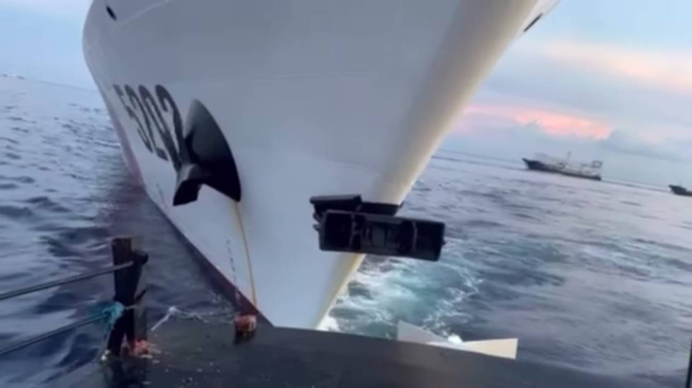 A China Coast Guard vessel collides with a Philippine resupply vessel in the disputed South China Sea on Sunday, in this image taken from video.