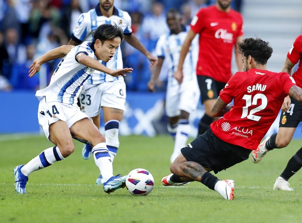 Real Sociedad's Takefusa Kubo (left) attacks the Mallorca goal during the second half of a La Liga game in San Sebastian, Spain, on Saturday.