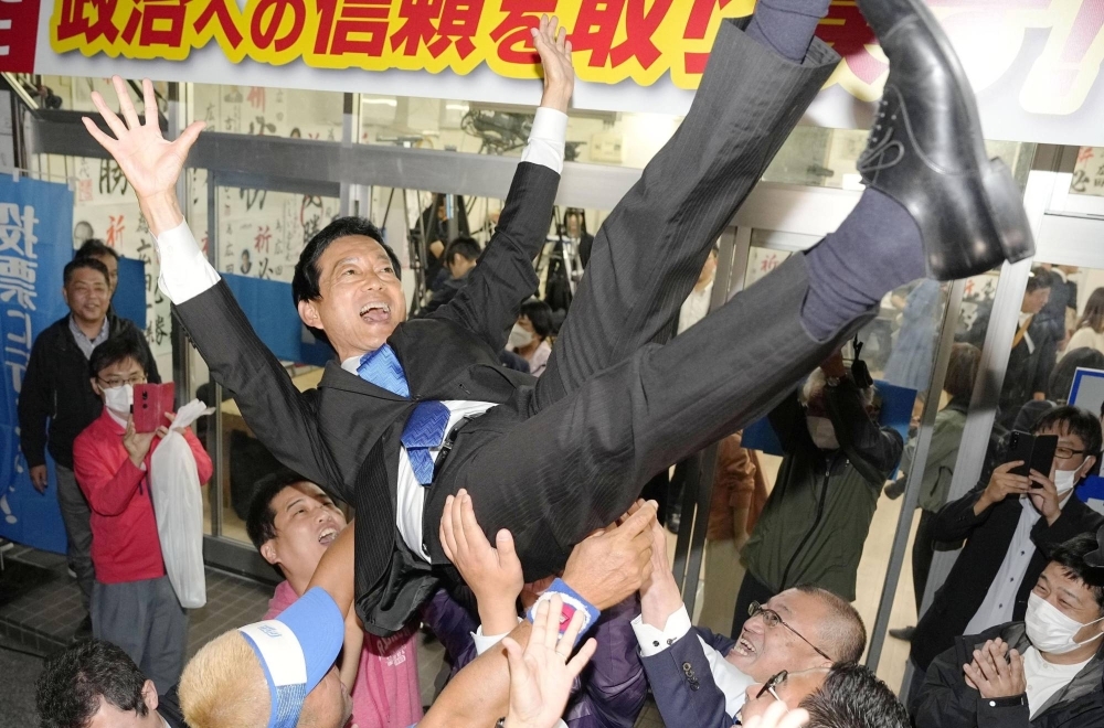 Hajime Hirota is lifted up after winning the Upper House seat in the Kochi-Tokushima district by election Sunday in the city of Kochi.