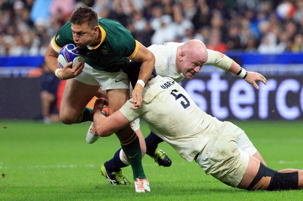 South Africa flyhalf Handre Pollard (left) is tackled by England's Dan Cole (center) and George Martin during their Rugby World Cup semifinal in Paris on Saturday.