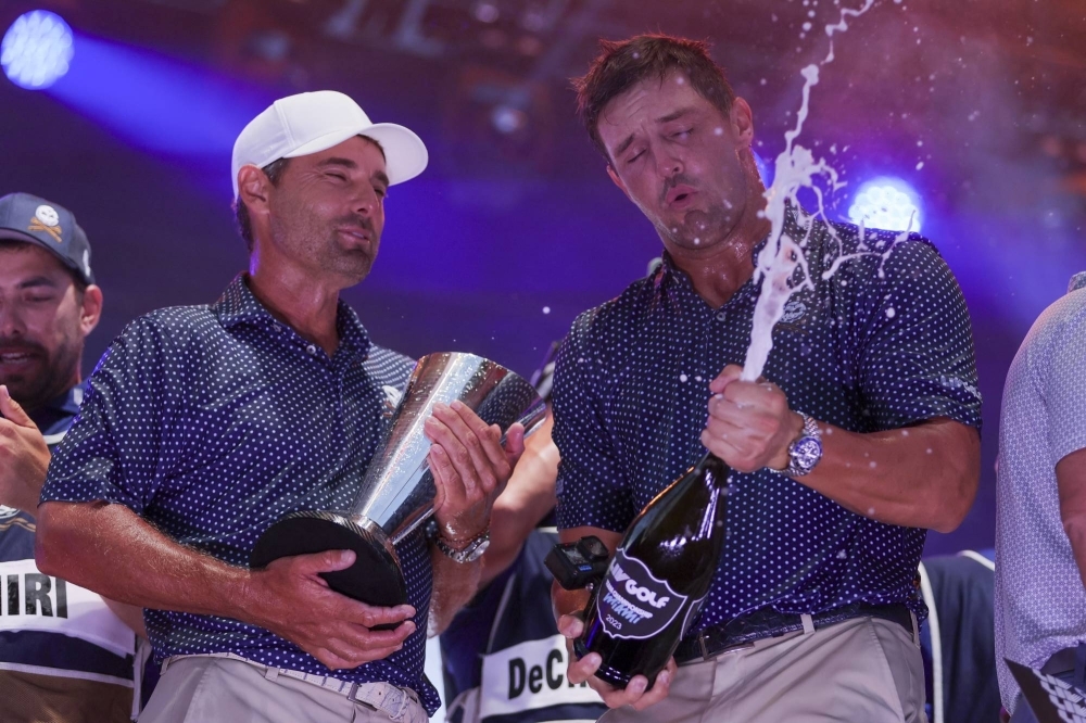 Crushers team captain Bryson Dechambeau (right) and Charles Howell III celebrates after winning the LIV Golf team championship at Trump National Doral, in Doral, Florida, on Sunday.