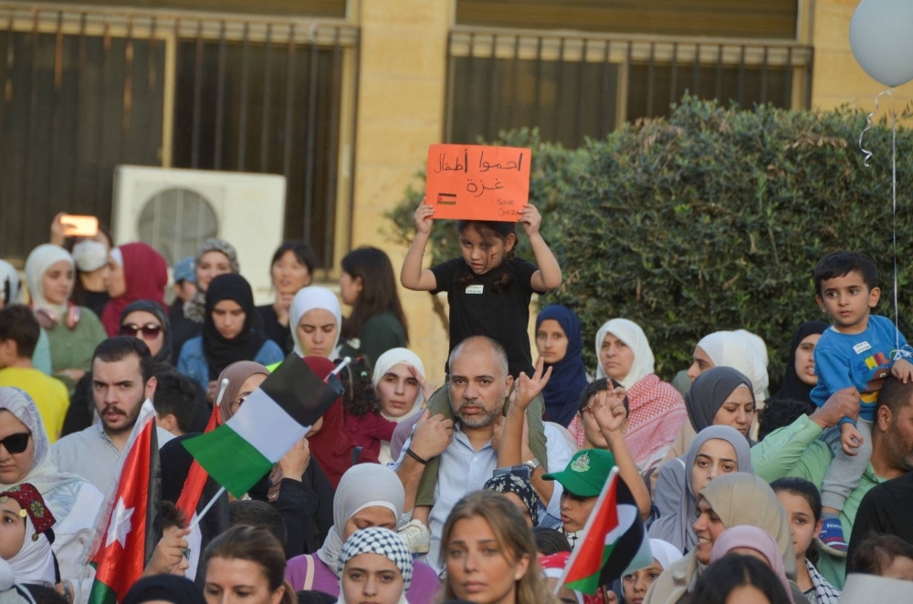 A girl holds a sign in a show of support for Gazan children in the besieged enclave, during the Israeli-Hamas conflict, in Amman, Jordan, on Sunday.