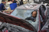 A man tries to start his car after Israeli airstrikes at the Nuseirat Market in the Gaza Strip on Monday. | Samar Abu Elouf / The New York Times