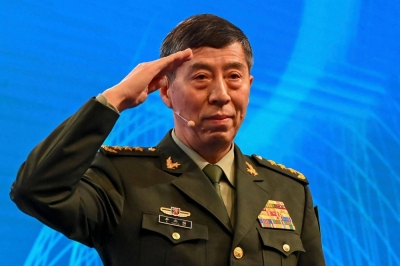 Chinese Defense Minister Li Shangfu salutes before delivering a speech during the 20th Shangri-La Dialogue summit in Singapore on June 4.