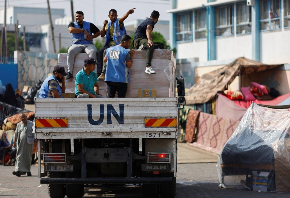 United Nations workers arrive to distribute aid to Palestinians in Khan Younis in the southern Gaza Strip on Monday.