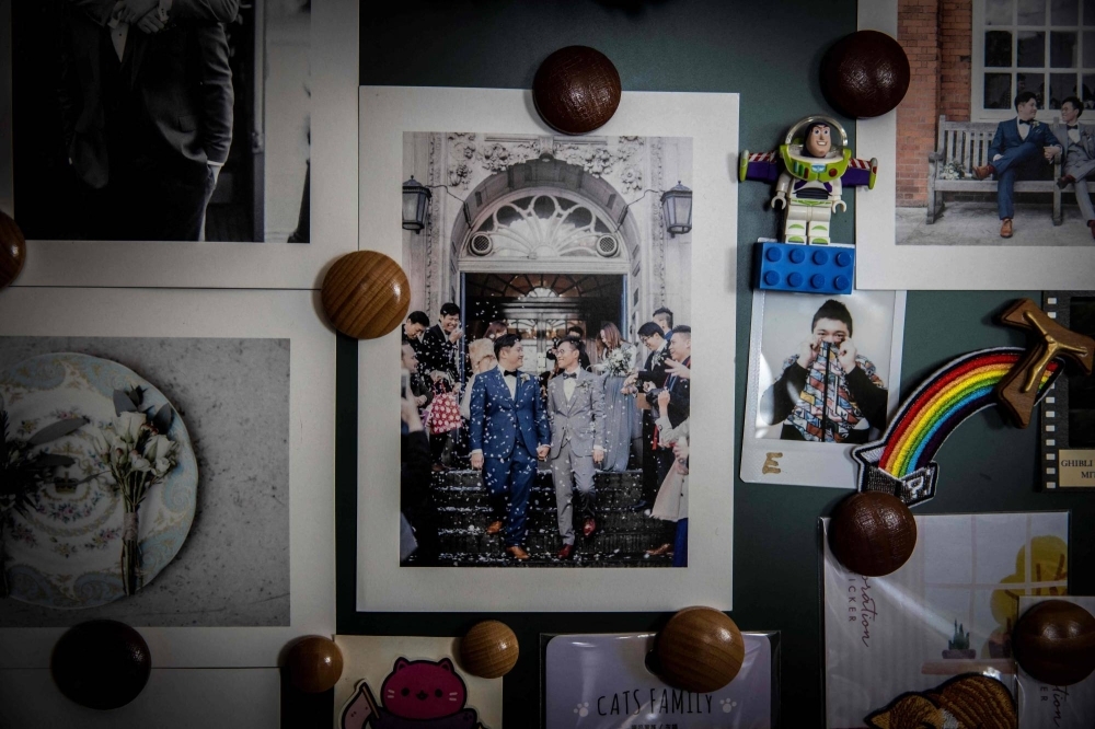 A photo of Henry Li and his husband, Edgar Ng, hangs on a wall in their apartment at Ma On Shan in Hong Kong. 