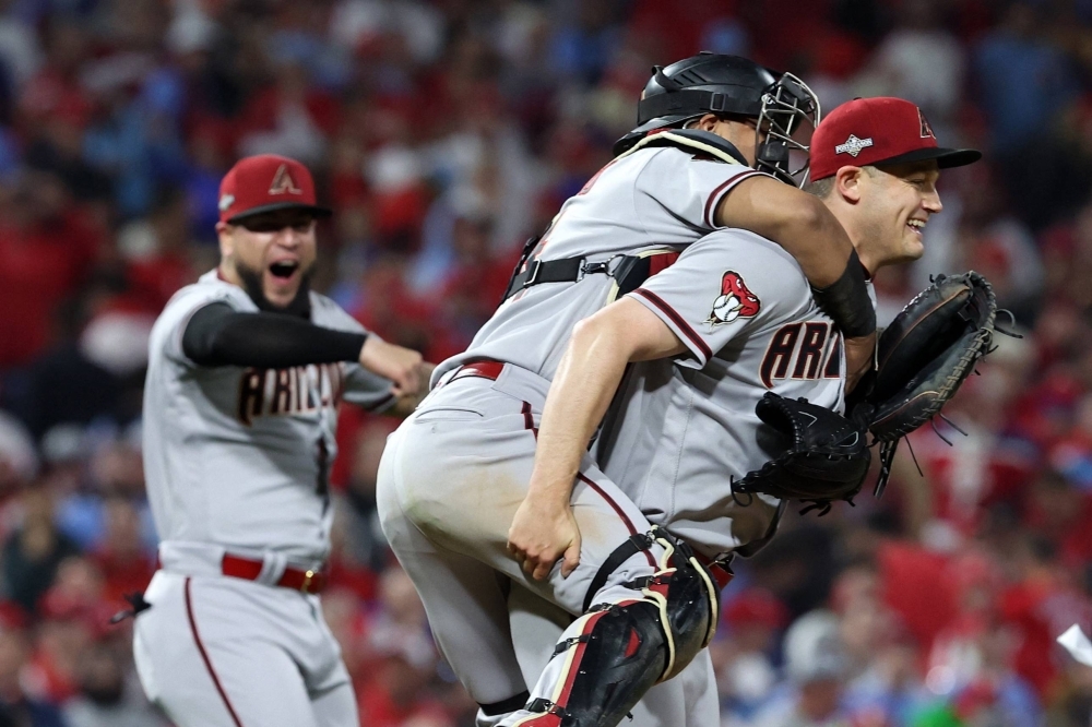 Relief pitcher Paul Sewald celebrates with catcher Gabriel Moreno after the Diamondbacks defeated the Phillies in Game 7 of the NLCS.