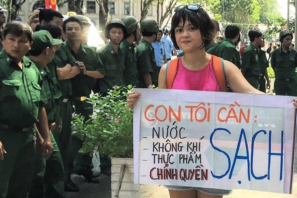 Vietnamese environment activist Hoang Thi Minh Hong holds a banner during a protest in Ho Chi Minh in 2017.