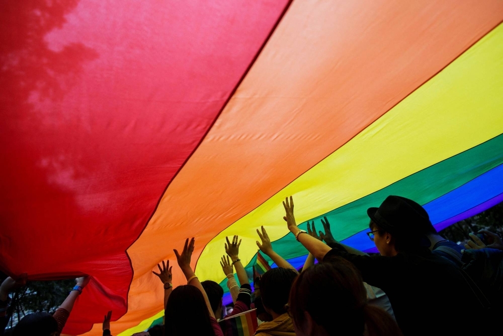 Participants hold a giant rainbow flag during a lesbian, gay, bisexual and transgender Pride Parade in Hong Kong