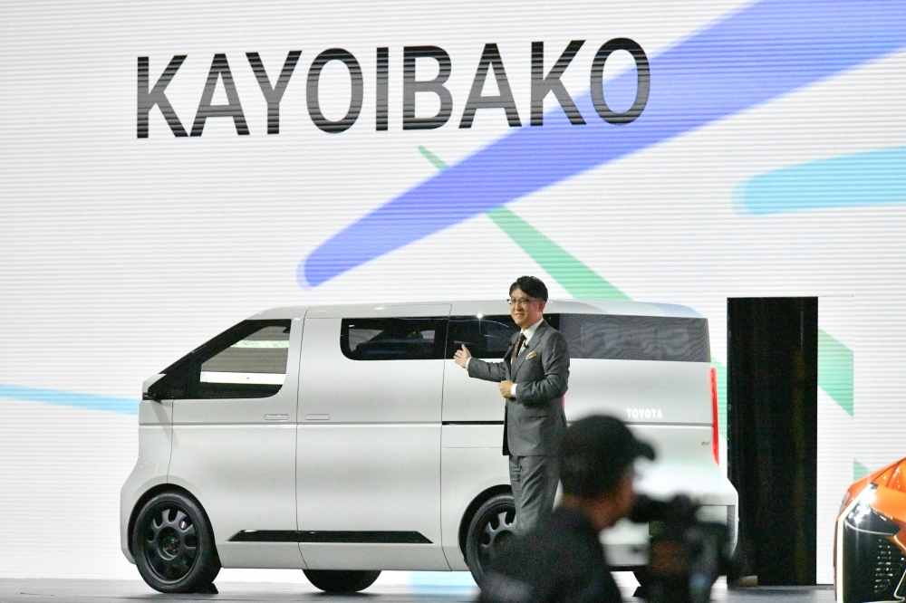 Toyota CEO Koji Sato speaks in front of the company's concept electric vehicle, dubbed Kayoibako, during a media briefing on Wednesday at the Japan Mobility Show in Tokyo. Toyota CEO Koji Sato speaks in front of the company's concept electric vehicle, dubbed Kayoibako, during a media briefing on Wednesday at the Japan Mobility Show in Tokyo.