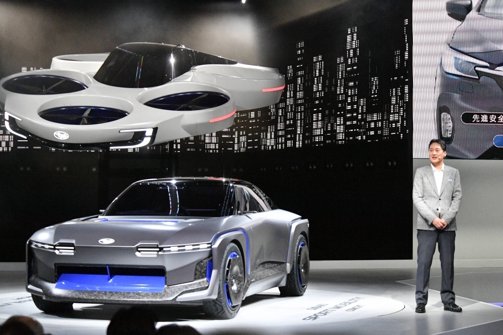 Subaru CEO Atsushi Osaki introduces a flying-car concept model and concept sport electric vehicle during a media briefing on Wednesday at the Japan Mobility Show in Tokyo. Subaru CEO Atsushi Osaki introduces a flying-car concept model and concept sport electric vehicle during a media briefing on Wednesday at the Japan Mobility Show in Tokyo.