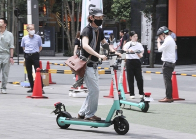 A participant tries an electric kick scooter at a safety workshop in Tokyo in June ahead of a relaxation of rules for riding the device in July.