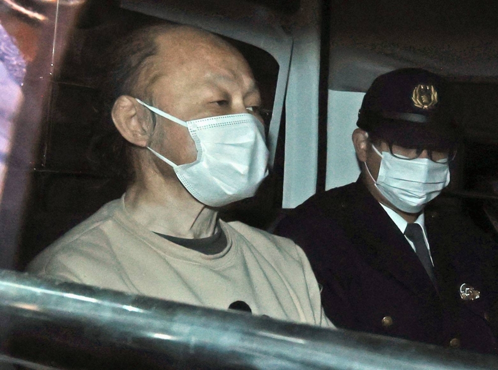 Hiroshi Watanabe is taken by police to prosecutors in Saitama Prefecture in February 2022.
