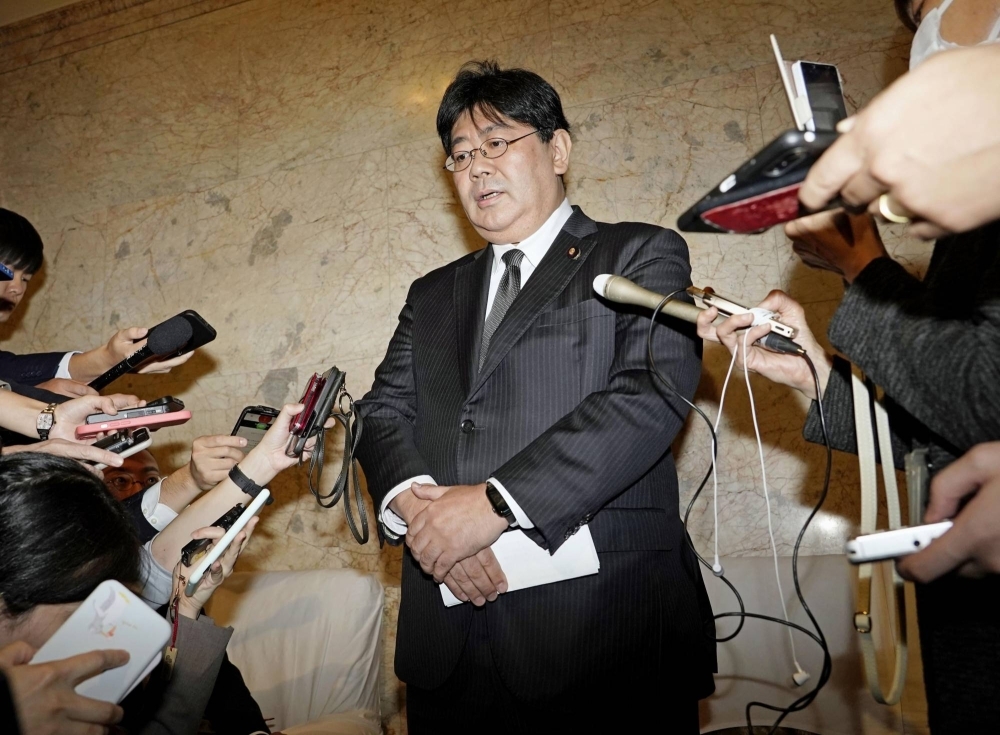 Taro Yamada, parliamentary vice minister for education, speaks to reporters at the parliament building in Tokyo on Thursday.