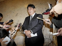 Taro Yamada, parliamentary vice minister for education, speaks to reporters at the parliament building in Tokyo on Thursday. | Kyodo