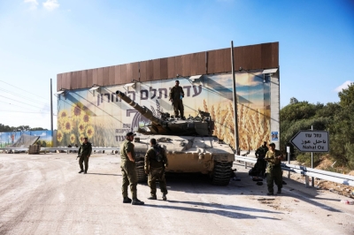 Israeli soldiers gather around a tank near the border with the Gaza Strip on Oct. 15. The IDF is preparing to conduct a ground offensive into the Palestinian territory.