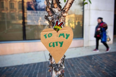 Cardboard hearts with messages are hung in the downtown area in Lewiston, Maine, on Thursday, in the aftermath of a mass shooting.