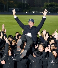 Pitcher Natsuki Takeuchi is tossed into the air in celebration by his Kokugakuin University teammates in Yokohama after he was taken in the first round of Japanese pro baseball's new-player entry draft on Thursday. | Kyodo