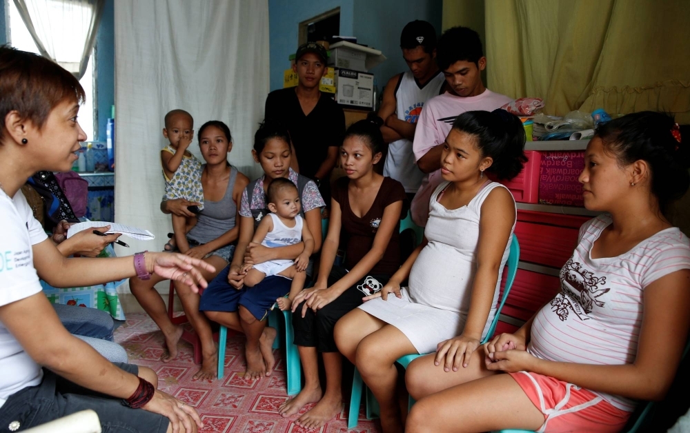 A community health worker speaks during a meeting with pregnant teenagers, teen mothers and their partners, in Navotas, Metro Manila, in 2016. 