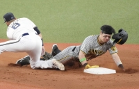 Tigers third baseman Teruaki Sato steals second against the Buffaloes in the third inning during Game 1 of the Japan Series at Kyocera Dome Osaka on Saturday. | KYODO