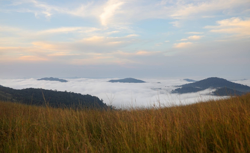 The cloudscape of the Veal Thom grasslands in Virachey National Park cushions the peaks that lead into the Annamite Mountains.