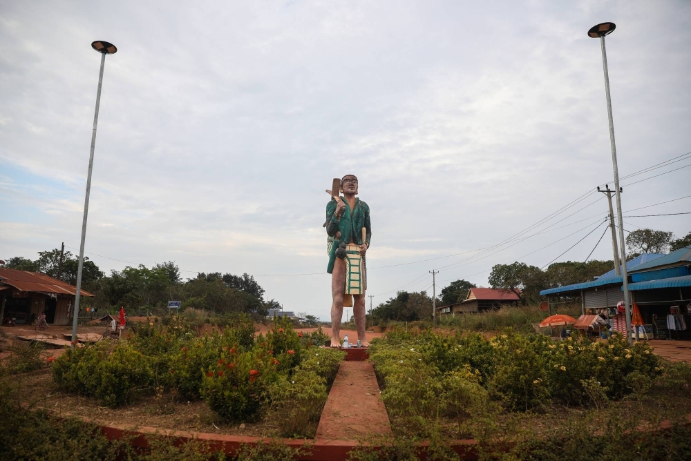 A statue of a Brau man adorns a roundabout in Taveng district, a gateway village to Cambodia’s Virachey National Park.
