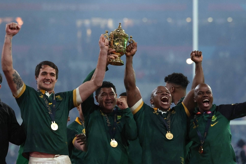 South African players celebrate with the Webb Ellis Cup after their win over New Zealand in the Rugby World Cup final on Saturday. 