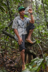 A community forest ranger from the Brau community smokes tobacco wrapped in a fresh leaf to ward off leeches. | Anton L. Delgado
