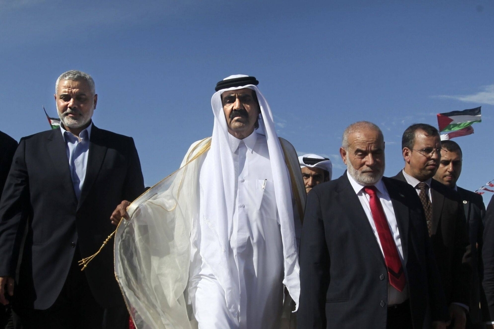 Hamas’ Ismail Haniyeh (left) and the former emir of Qatar arrive at a cornerstone-laying ceremony for the new Hamad residential neighborhood in Gaza in 2012.  