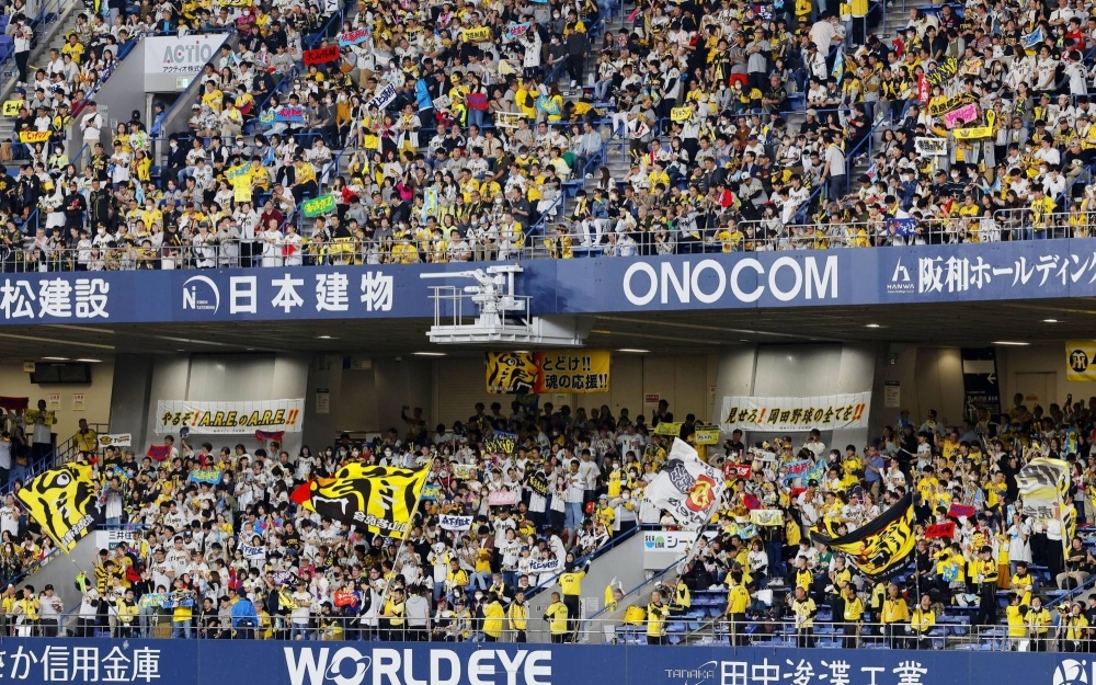 Tigers fans during Game 1 of the Japan Series against the Buffaloes, at Kyocera Dome Osaka on Saturday. The Tigers are known for their high attendance figures and rowdy celebrations among the team's loyal fans.