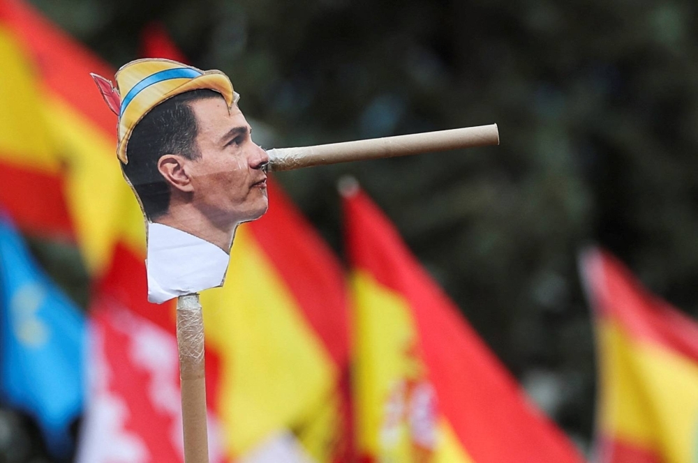 A protestor depicts Spanish Prime Minister Pedro Sanchez as the fictional character Pinocchio during a protest in Madrid on Sunday.